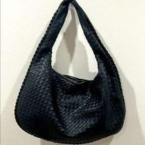 Super cute and trendy black woven faux leather bag!